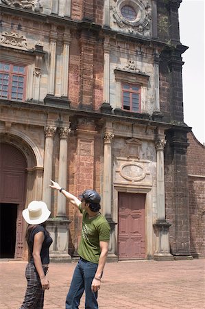 Side profile of a young couple standing in front of a building, Goa, India Stock Photo - Premium Royalty-Free, Code: 630-01876658