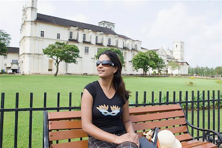 simsearch:630-01876693,k - Young woman sitting on a bench with a cathedral in the background, Se Cathedral, Goa, India Stock Photo - Premium Royalty-Free, Code: 630-01876696