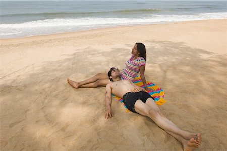 High angle view of a young couple relaxing on the beach Stock Photo - Premium Royalty-Free, Code: 630-01877065