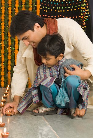 simsearch:630-01873032,k - Young man lighting diwali lamps with his son Stock Photo - Premium Royalty-Free, Code: 630-01877226