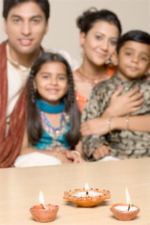 simsearch:630-01873032,k - Portrait of a young couple sitting together with their son and daughter Stock Photo - Premium Royalty-Free, Code: 630-01877274