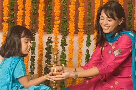 simsearch:630-01873032,k - Girl lighting a oil lamp with her mother Stock Photo - Premium Royalty-Free, Code: 630-01877309