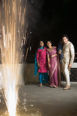 simsearch:630-01873032,k - Mid adult man with two young women and a boy celebrating the diwali festival Stock Photo - Premium Royalty-Free, Code: 630-01877391