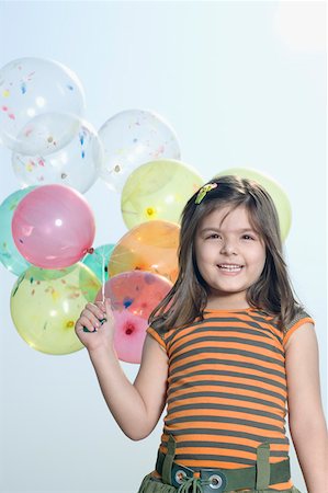 Portrait of a girl holding balloons and smiling Foto de stock - Sin royalties Premium, Código: 630-01877454