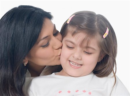 simsearch:630-02219943,k - Close-up of a mid adult woman kissing her daughter Stock Photo - Premium Royalty-Free, Code: 630-01877486