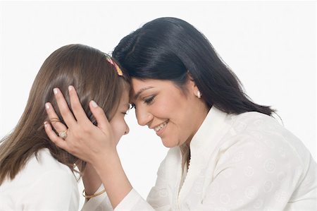 shoulders little girl - Side profile of a mid adult woman smiling with her daughter Stock Photo - Premium Royalty-Free, Code: 630-01877487