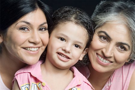 Portrait of a girl smiling with her mother and grandmother Stock Photo - Premium Royalty-Free, Code: 630-01877534