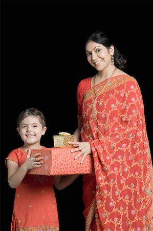 simsearch:630-01873032,k - Portrait of a mid adult woman giving gifts to her daughter Stock Photo - Premium Royalty-Free, Code: 630-01877604