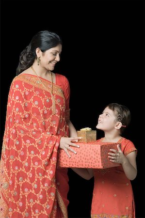 simsearch:630-01873032,k - Mid adult woman giving gifts to her daughter Stock Photo - Premium Royalty-Free, Code: 630-01877605