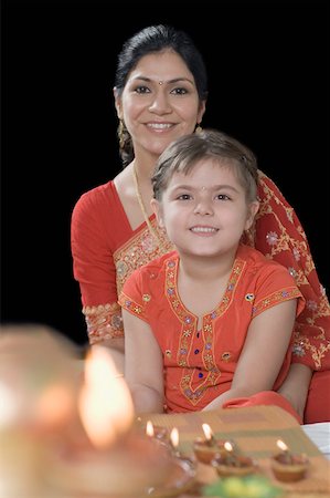 simsearch:630-01873032,k - Portrait of a mid adult woman smiling with her daughter Stock Photo - Premium Royalty-Free, Code: 630-01877613