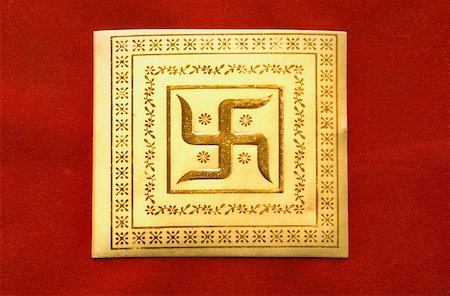 Close-up of a swastika on a wedding invitation card Stock Photo - Premium Royalty-Free, Code: 630-01877845