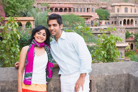 rajasthan clothes for women - Couple smiling and leaning against wall, Neemrana Fort Palace, Neemrana, Alwar, Rajasthan, India Stock Photo - Premium Royalty-Free, Code: 630-01872413