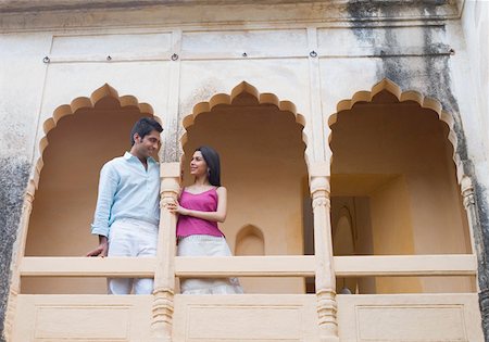 rajasthan clothes for women - Low angle view of a young couple leaning against a column of a palace, Neemrana Fort Palace, Neemrana, Alwar, Rajasthan, India Stock Photo - Premium Royalty-Free, Code: 630-01872428
