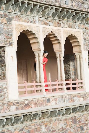 rajasthan clothes for women - Portrait of a young woman standing in the balcony of a palace, Neemrana Fort Palace, Neemrana, Alwar, Rajasthan, India Stock Photo - Premium Royalty-Free, Code: 630-01872540