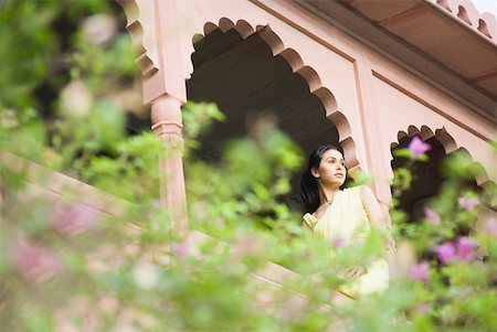 rajasthan clothes for women - Young woman sitting on the balustrade of a palace, Neemrana Fort Palace, Neemrana, Alwar, Rajasthan, India Stock Photo - Premium Royalty-Free, Code: 630-01872543