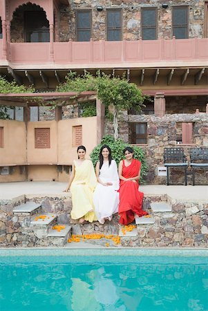 rajasthan clothes for women - Three young women sitting at the poolside, Neemrana Fort Palace, Neemrana, Alwar, Rajasthan, India Stock Photo - Premium Royalty-Free, Code: 630-01872551