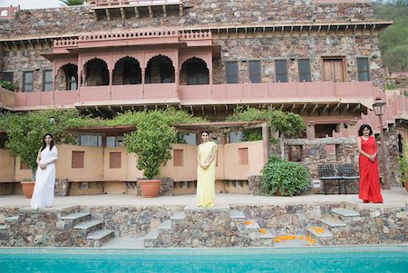 simsearch:630-01872552,k - Three young women standing at the poolside of a palace, Neemrana Fort Palace, Neemrana, Alwar, Rajasthan, India Stock Photo - Premium Royalty-Free, Code: 630-01872552