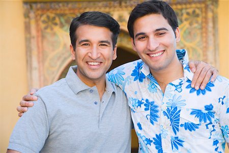 Portrait of a mid adult man and a young man smiling Stock Photo - Premium Royalty-Free, Code: 630-01872876
