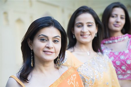 Portrait of two mid adult women and a young woman standing in a row Stock Photo - Premium Royalty-Free, Code: 630-01872936