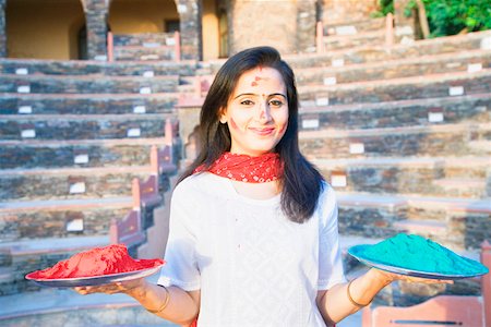 simsearch:630-01872552,k - Portrait of a mid adult woman holding plates of powder paint and smiling, Neemrana Fort Palace Neemrana, Alwar, Rajasthan, India Stock Photo - Premium Royalty-Free, Code: 630-01873006