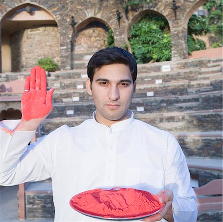 simsearch:630-01872552,k - Portrait of a young man holding a plate of powder paint and showing his palm, Neemrana Fort Palace, Neemrana, Alwar, Rajasthan, India Stock Photo - Premium Royalty-Free, Code: 630-01873002