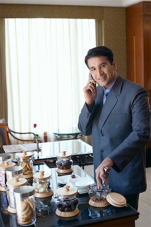 simsearch:630-01873072,k - Portrait of a businessman talking on a mobile phone and smiling Stock Photo - Premium Royalty-Free, Code: 630-01873094