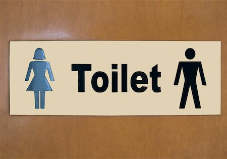 symbol for female - Close-up of a male and a female sign on a toilet door Stock Photo - Premium Royalty-Free, Code: 630-01873091