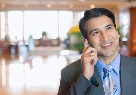 simsearch:630-01873072,k - Close-up of a businessman talking on a mobile phone and smiling Stock Photo - Premium Royalty-Free, Code: 630-01873231