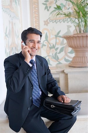 simsearch:630-01873072,k - Businessman talking on a mobile phone and smiling Stock Photo - Premium Royalty-Free, Code: 630-01873285