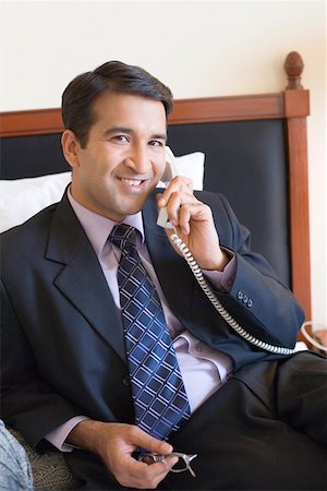 simsearch:630-01873072,k - Portrait of a businessman talking on the telephone and smiling Stock Photo - Premium Royalty-Free, Code: 630-01873302