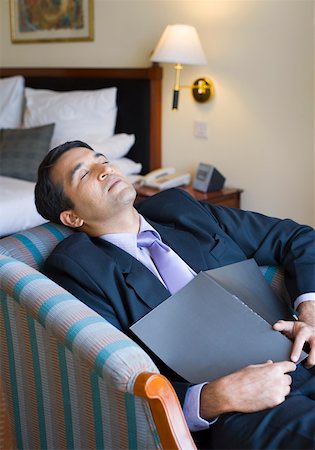 Businessman sleeping on a couch Stock Photo - Premium Royalty-Free, Code: 630-01873316