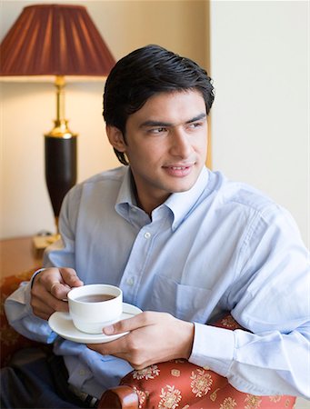 simsearch:630-01873072,k - Close-up of a young man holding a cup of tea Stock Photo - Premium Royalty-Free, Code: 630-01873345