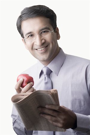 simsearch:640-01350815,k - Portrait of a businessman holding an apple and a newspaper Stock Photo - Premium Royalty-Free, Code: 630-01873379