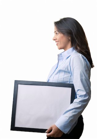 Side profile of a businesswoman holding a blank picture frame and smiling Stock Photo - Premium Royalty-Free, Code: 630-01873388