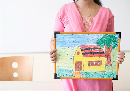 Mid section view of a female teacher holding a painting Stock Photo - Premium Royalty-Free, Code: 630-01873492