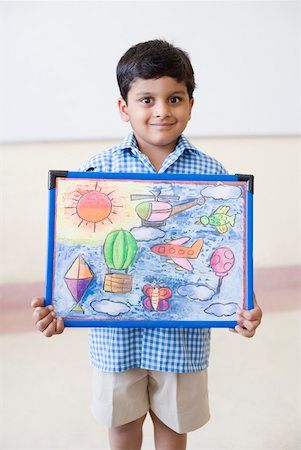 Portrait of a schoolboy holding a painting and smiling Stock Photo - Premium Royalty-Free, Code: 630-01873556