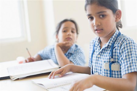 school head girl - Portrait of a schoolgirl sitting at a desk with her friend sitting beside her Stock Photo - Premium Royalty-Free, Code: 630-01873579