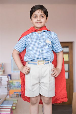 Schoolboy imitating to be a superhero Foto de stock - Sin royalties Premium, Código: 630-01873620