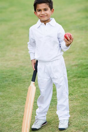 Boy holding a cricket bat and a cricket ball Stock Photo - Premium Royalty-Free, Code: 630-01873675