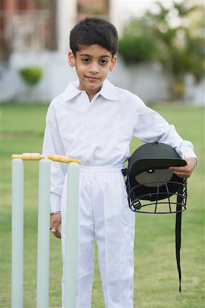 Portrait of a boy holding a sports helmet and smiling Stock Photo - Premium Royalty-Free, Code: 630-01873671