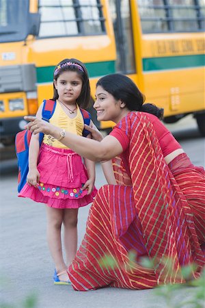 school bus - School teacher pointing forward with her student standing beside her Stock Photo - Premium Royalty-Free, Code: 630-01873698