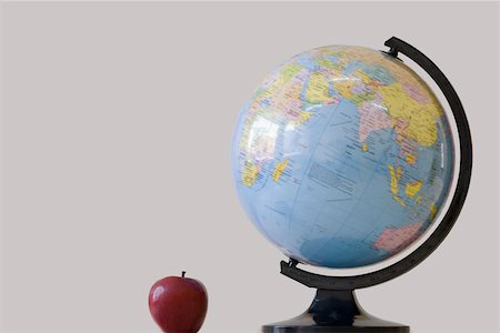 Close-up of a globe with an apple Stock Photo - Premium Royalty-Free, Code: 630-01873757