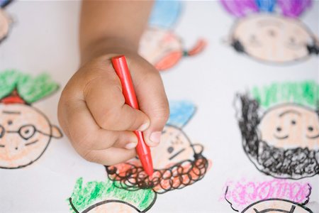 Close-up of child's hand drawing on a sheet of paper Stock Photo - Premium Royalty-Free, Code: 630-01873771
