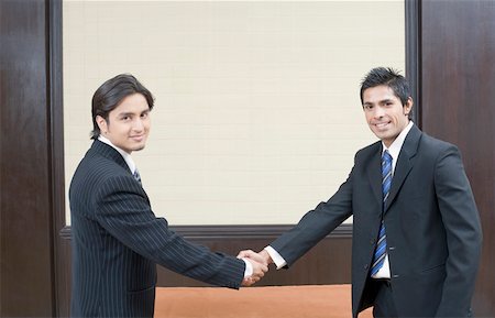 Portrait of two businessmen shaking their hands Stock Photo - Premium Royalty-Free, Code: 630-01873985