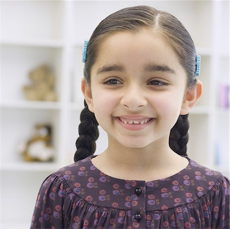 preteen girl pigtails - Close-up of a girl smiling Stock Photo - Premium Royalty-Free, Code: 630-02219485