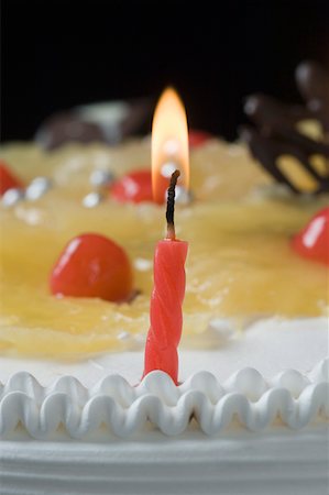 simsearch:630-02219911,k - Close-up of a lit candle on a birthday cake Stock Photo - Premium Royalty-Free, Code: 630-02219510