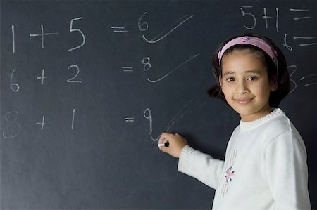 simsearch:625-01250891,k - Portrait of a girl solving mathematical symbols on a blackboard Stock Photo - Premium Royalty-Free, Code: 630-02219567