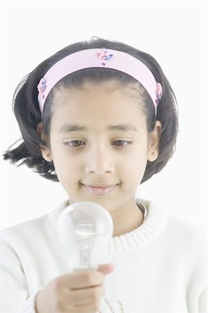 simsearch:630-02221120,k - Girl holding a light bulb Stock Photo - Premium Royalty-Free, Code: 630-02219571