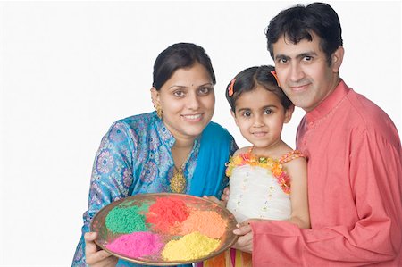 simsearch:630-02219943,k - Portrait of a mid adult couple with their daughter holding a plate of powder paint and smiling Stock Photo - Premium Royalty-Free, Code: 630-02219587