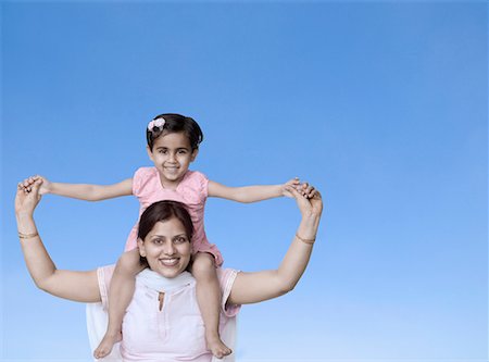 simsearch:630-02219943,k - Portrait of a girl sitting on her mother's shoulder and smiling Stock Photo - Premium Royalty-Free, Code: 630-02219598